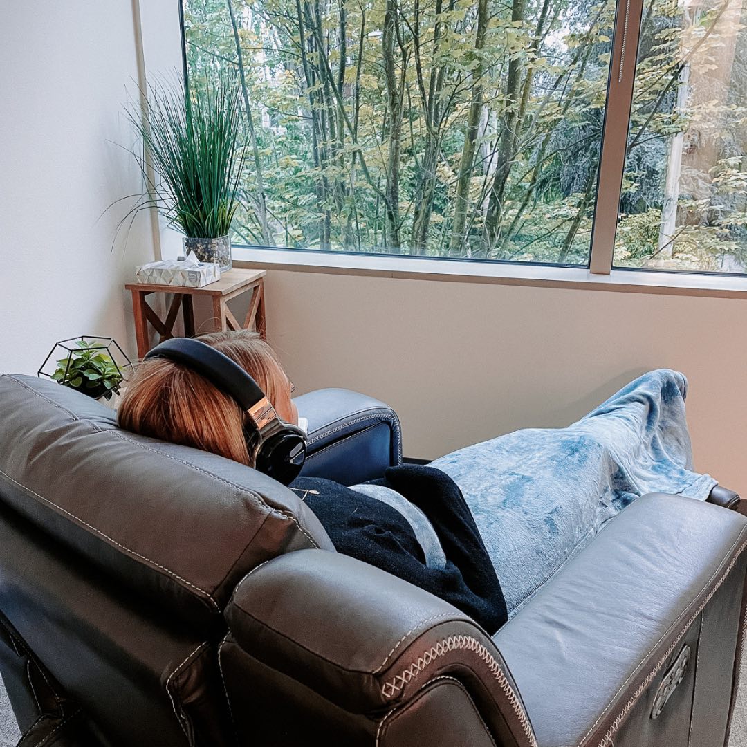 Patient relaxing with headphones in treatment recliner