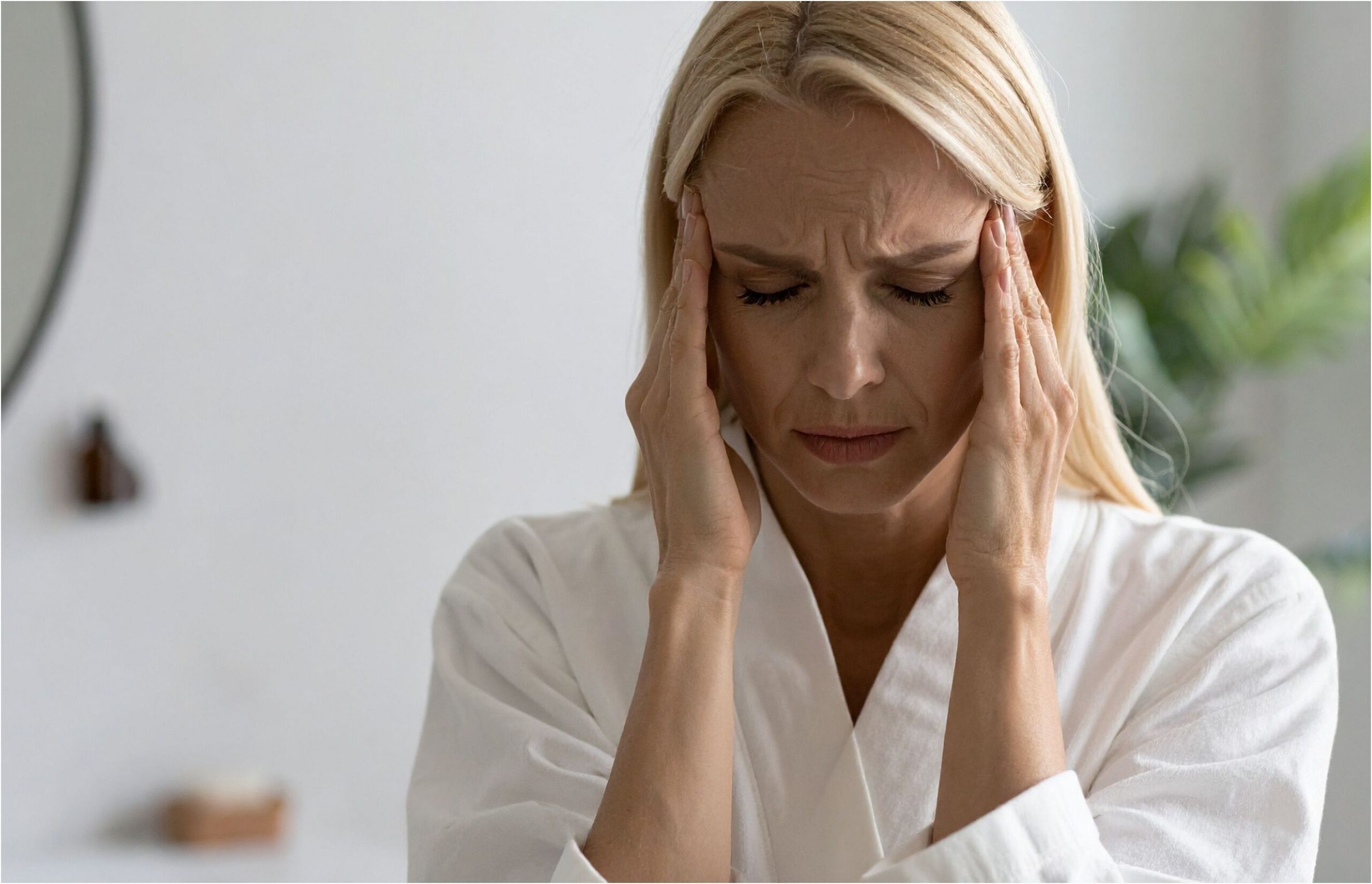 woman touching temples in pain