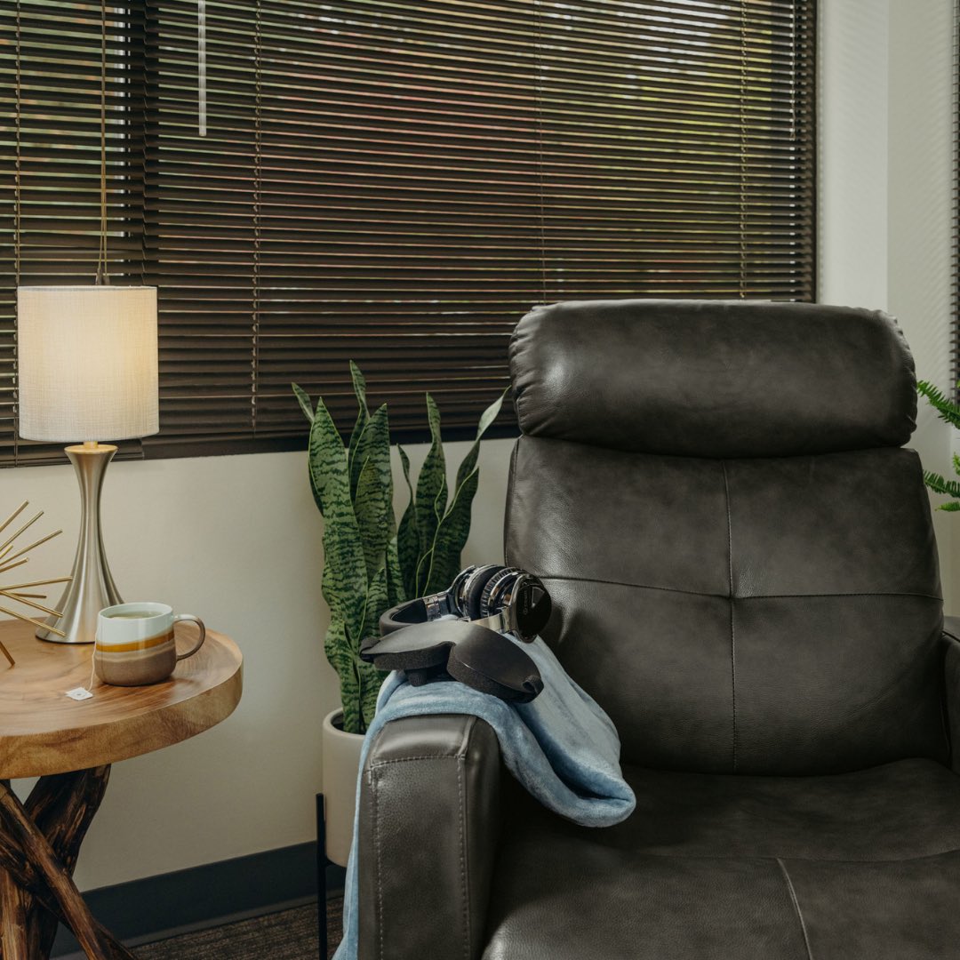 Treatment room with forest view and recliner